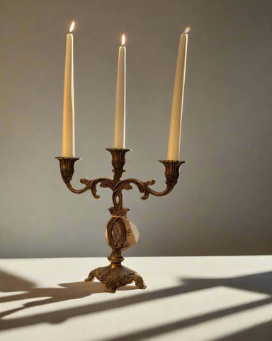 Vintage brass candleholder with bronze and gold finish, holds three candles, ornate decorative design