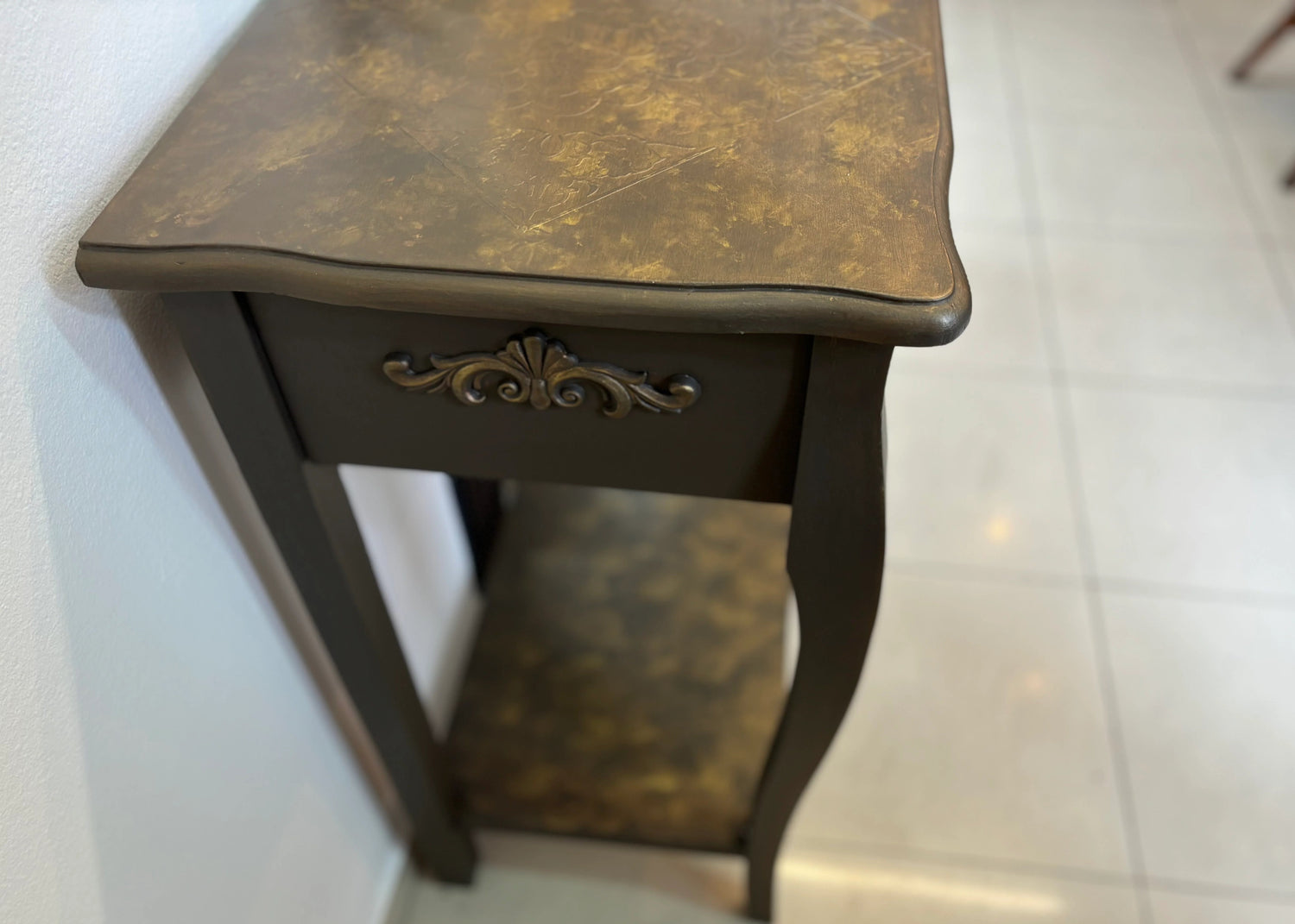 Refurbished vintage console table with a distressed wood finish and ornate carvings, perfect for adding character to entryways or living rooms. This stylish table combines classic design with modern functionality, making it ideal for displaying decor or as a chic storage solution.