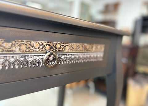 Refurbished vintage console table with a distressed wood finish and ornate carvings, perfect for adding character to entryways or living rooms. This stylish table combines classic design with modern functionality, making it ideal for displaying decor or as a chic storage solution.