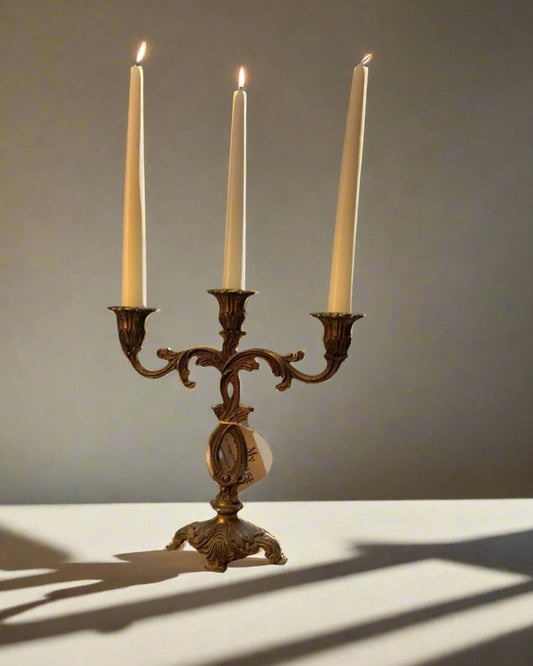 Vintage brass candleholder with bronze and gold finish, holds three candles, ornate decorative design