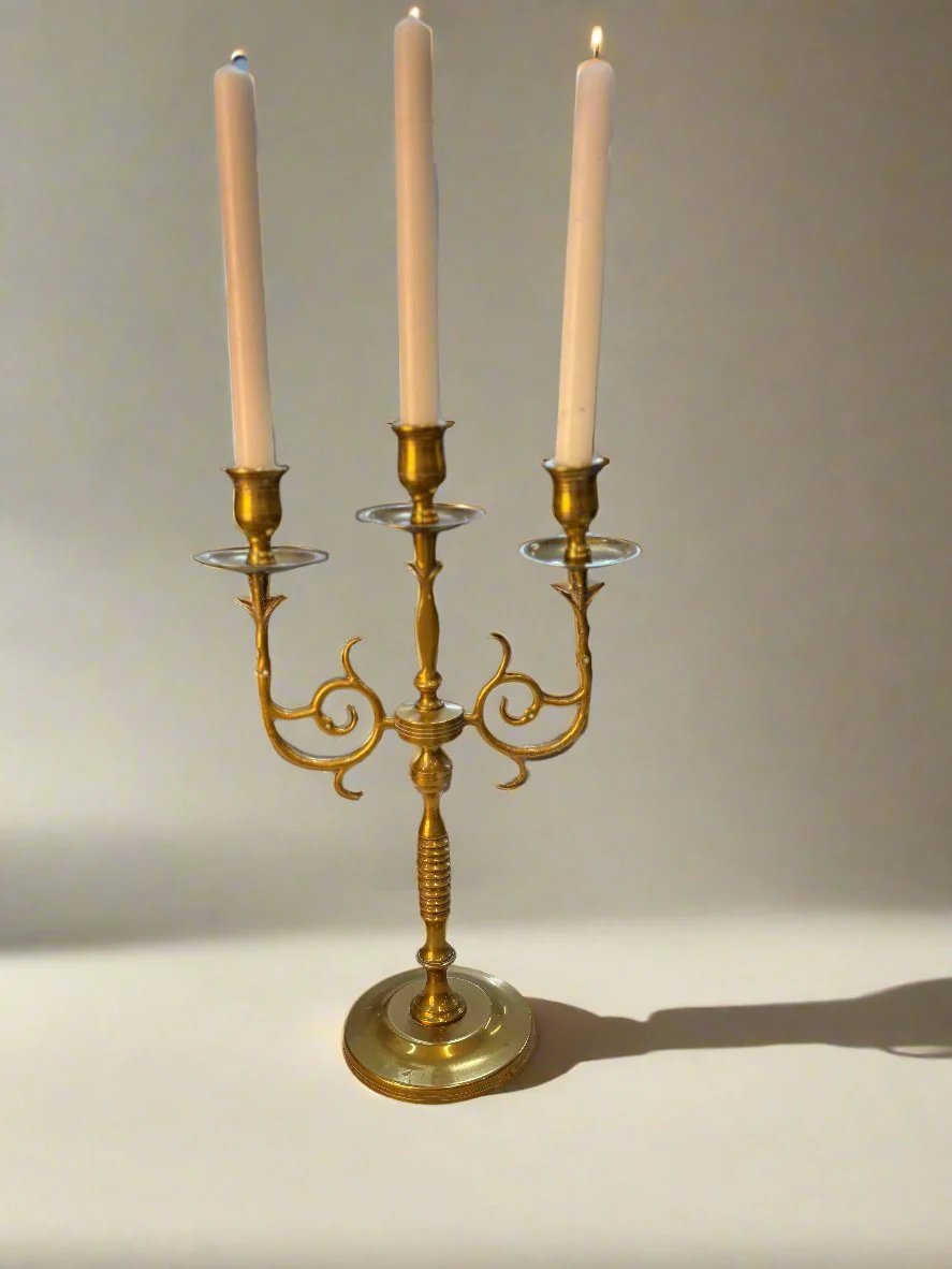 Elegant golden candle holder crafted from high-quality brass, featuring a sleek, modern design with intricate detailing. Perfect for adding a touch of sophistication to any room, this candle holder enhances the ambiance of dining tables, mantels, or home decor displays.