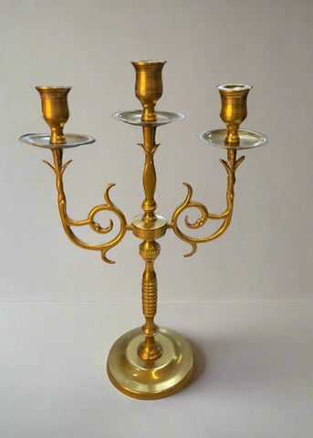 Elegant golden candle holder crafted from high-quality brass, featuring a sleek, modern design with intricate detailing. Perfect for adding a touch of sophistication to any room, this candle holder enhances the ambiance of dining tables, mantels, or home decor displays.